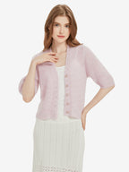 Model wearing Lanly Cashmere Women's Mohair Short Sleeve Cardigan in soft pink.